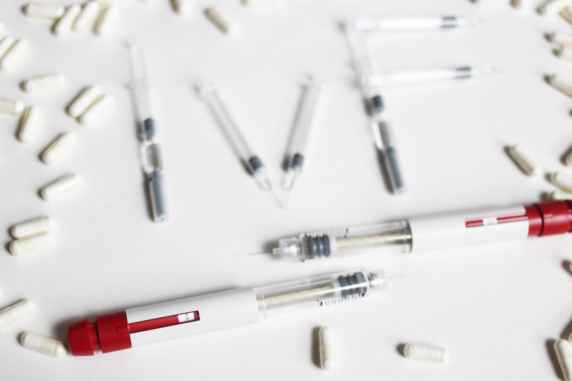 Fertility needles and medication laid out to spell IVF